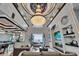 Spacious living room with high ceilings, a large chandelier, fireplace, and ocean views at 6526 Surfside Blvd, Apollo Beach, FL 33572
