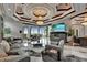 Bright living room featuring a coffered ceiling with chandelier and views through large windows at 6526 Surfside Blvd, Apollo Beach, FL 33572