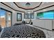 Spacious bedroom showcasing a modern tray ceiling, tv, lounge area, and balcony doors at 6526 Surfside Blvd, Apollo Beach, FL 33572