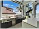 Modern outdoor kitchen featuring stainless steel appliances and stunning waterfront views at 6526 Surfside Blvd, Apollo Beach, FL 33572