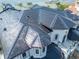 An aerial shot showcases the home's architectural roof features and its proximity to the bay at 6526 Surfside Blvd, Apollo Beach, FL 33572