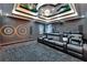 A modern theater room features tiered seating, a projector, and premium sound system for the ultimate viewing experience at 6526 Surfside Blvd, Apollo Beach, FL 33572