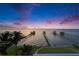 Picturesque waterfront property with private docks, lush landscaping, and beautiful sunset views at 6526 Surfside Blvd, Apollo Beach, FL 33572