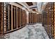 A temperature-controlled wine room boasts custom shelving and elegant design, perfect for wine enthusiasts at 6526 Surfside Blvd, Apollo Beach, FL 33572