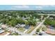 An aerial view shows the home with mature trees and residential neighborhood, with a cityscape in the distance at 6816 S Hesperides St, Tampa, FL 33616