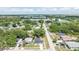 An aerial view shows the home in a residential neighborhood close to the water, with a cityscape in the distance at 6816 S Hesperides St, Tampa, FL 33616