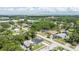An aerial view shows the home in a residential neighborhood with mature trees and close to commercial areas at 6816 S Hesperides St, Tampa, FL 33616