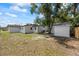 Backyard featuring large trees and a white shed at 6816 S Hesperides St, Tampa, FL 33616