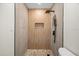 Shower features sleek fixtures and a stone pebble floor at 6816 S Hesperides St, Tampa, FL 33616