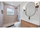 Modern bathroom features walk-in shower, floating vanity, and updated fixtures at 6816 S Hesperides St, Tampa, FL 33616