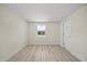 Bright bedroom with neutral walls, light wood-look floors, recessed lighting, and white trim at 6816 S Hesperides St, Tampa, FL 33616