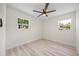 Bright bedroom with light wood-look floors and ceiling fan at 6816 S Hesperides St, Tampa, FL 33616