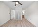 Bright bedroom featuring a ceiling fan, wood floors, closet, and multiple doors at 6816 S Hesperides St, Tampa, FL 33616