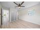 Bright bedroom featuring a ceiling fan, wood floors, closet, and natural light at 6816 S Hesperides St, Tampa, FL 33616