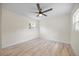 Bright bedroom featuring a ceiling fan, wood floors, a window, and natural light at 6816 S Hesperides St, Tampa, FL 33616