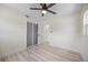 Bedroom featuring ceiling fan, light wood-look floors and sliding door closet at 6816 S Hesperides St, Tampa, FL 33616