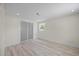 Neutral bedroom with light wood-look floors, recessed lighting, and sliding glass closet doors at 6816 S Hesperides St, Tampa, FL 33616
