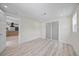 Bright bedroom featuring recessed lighting, light wood-look floors, and doorway to kitchen at 6816 S Hesperides St, Tampa, FL 33616