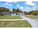 A charming home featuring a freshly painted exterior, a well-manicured lawn, and a new walkway with a driveway at 6816 S Hesperides St, Tampa, FL 33616