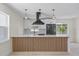 Stylish kitchen showcasing a center island with a bar, white cabinets, and modern appliances at 6816 S Hesperides St, Tampa, FL 33616