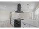 Spacious kitchen with marble countertops, black range hood, and contemporary pendant lighting at 6816 S Hesperides St, Tampa, FL 33616