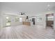 Inviting living room with new floors, transitioning to a modern kitchen with updated appliances at 6816 S Hesperides St, Tampa, FL 33616