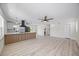 Open-concept living room featuring new flooring, kitchen with large island, and modern finishes at 6816 S Hesperides St, Tampa, FL 33616