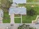 Top-down view of a home with manicured lawns, beautiful landscaping, stone driveway, and easy street access at 7224 Park S St, St Pete Beach, FL 33707