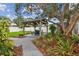 Relaxing backyard featuring a wooden gazebo with seating and a beautifully landscaped yard, perfect for outdoor entertaining at 7224 Park S St, St Pete Beach, FL 33707