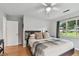 Bedroom with a ceiling fan and large window allowing for natural light at 7224 Park S St, St Pete Beach, FL 33707