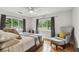 Comfortable bedroom features natural light through large windows and a cozy sitting area at 7224 Park S St, St Pete Beach, FL 33707