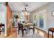 Dining room featuring stylish light fixture, table, and chairs, with a sliding barn door at 7224 Park S St, St Pete Beach, FL 33707