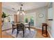 Charming dining room with a modern light fixture, sliding door to the outside, and hardwood floors at 7224 Park S St, St Pete Beach, FL 33707