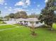 Charming home featuring a well-maintained lawn, fresh exterior paint, and a welcoming facade at 7224 Park S St, St Pete Beach, FL 33707