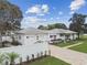 Beautiful home with a spacious yard, privacy fence, fresh exterior paint, and a brick driveway at 7224 Park S St, St Pete Beach, FL 33707