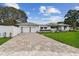 Beautiful home with a driveway leading to a two-car garage and meticulously maintained landscaping at 7224 Park S St, St Pete Beach, FL 33707