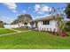 Attractive single-story home with a well-maintained lawn, garden and a driveway with ample parking space at 7224 Park S St, St Pete Beach, FL 33707