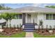 Inviting front porch with well-manicured landscaping, stone walkway, and fresh exterior paint at 7224 Park S St, St Pete Beach, FL 33707