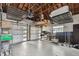 Spacious garage with exposed wood ceiling and ample storage shelving at 7224 Park S St, St Pete Beach, FL 33707