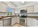 Bright kitchen features granite countertops, stainless steel appliances, and white cabinets at 7224 Park S St, St Pete Beach, FL 33707