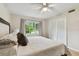 Comfortable bedroom features natural light through a large window and closet at 7224 Park S St, St Pete Beach, FL 33707