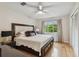 Comfortable bedroom features natural light through a large window and a cozy ceiling fan at 7224 Park S St, St Pete Beach, FL 33707
