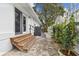 Inviting side yard with brick patio, wooden steps, and decorative plantings at 7224 Park S St, St Pete Beach, FL 33707