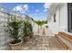 Charming side yard with decorative planters, stone pathway, and trellised fence at 7224 Park S St, St Pete Beach, FL 33707