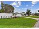Corner lot showing beautiful home with large yard and attractive white fence at 7224 Park S St, St Pete Beach, FL 33707
