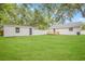Backyard with a shed, white fence, and a wooden deck attached to a freshly painted house at 731 38Th N Ave, St Petersburg, FL 33704