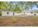 Backyard with a shed, white fence, and a wooden deck attached to a freshly painted house at 731 38Th N Ave, St Petersburg, FL 33704
