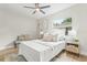 Comfortable bedroom with decorative pillows, ceiling fan, light colored walls, and wood floors at 731 38Th N Ave, St Petersburg, FL 33704