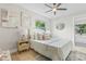 Comfortable bedroom with decorative pillows, ceiling fan, light colored walls, and wood floors at 731 38Th N Ave, St Petersburg, FL 33704