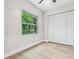 Bedroom with a large window offering leafy, green views and a closet with white paneled doors at 731 38Th N Ave, St Petersburg, FL 33704